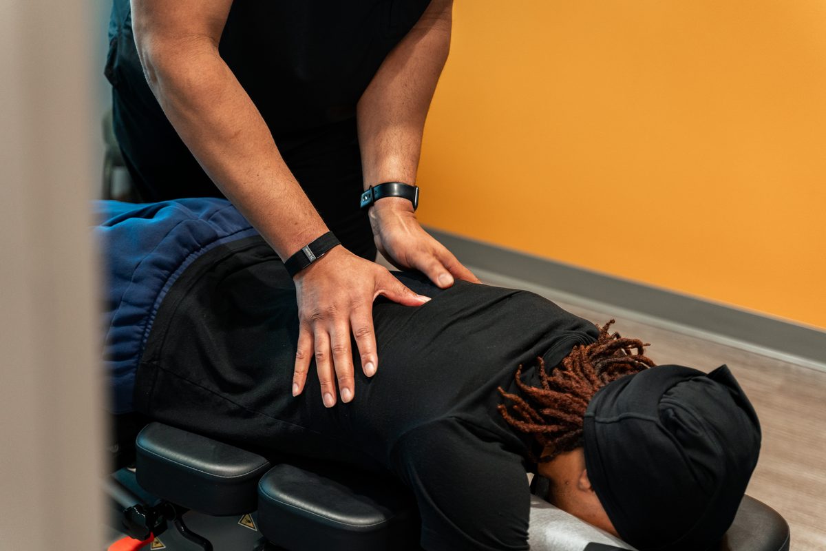Close-up of a chiropractor's hands performing a precision spinal adjustment