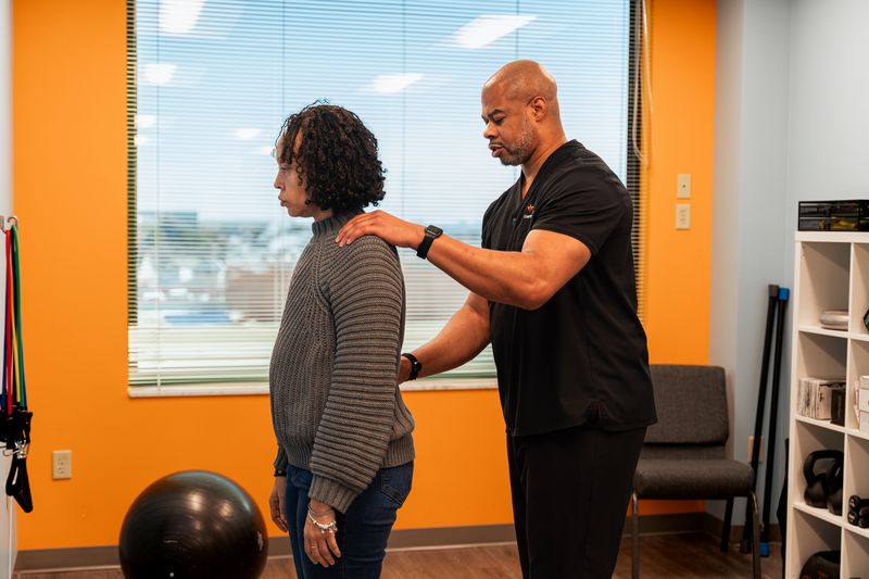 Doctor consulting with a patient at CJW Chiropractic Solutions