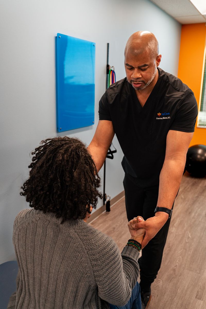 Patient receiving manual therapy in a bright, modern treatment room
